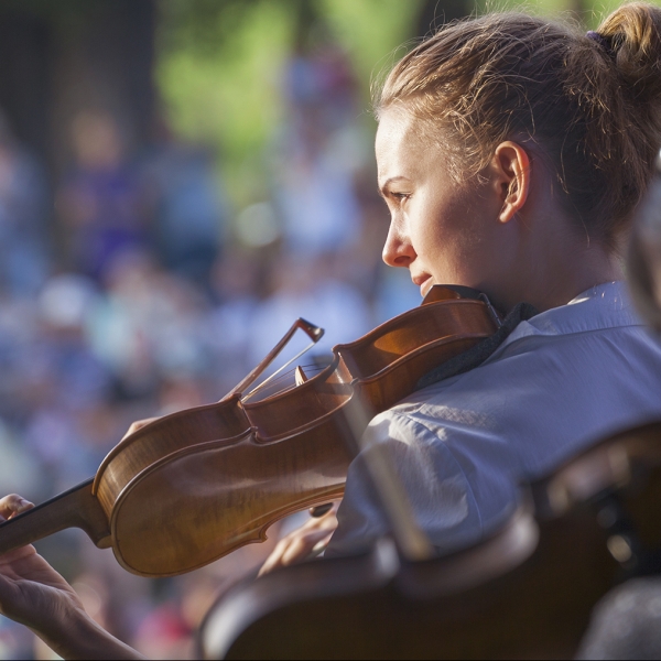 Young woman playing the violin at outdoors